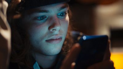 a young man looking at his cell phone