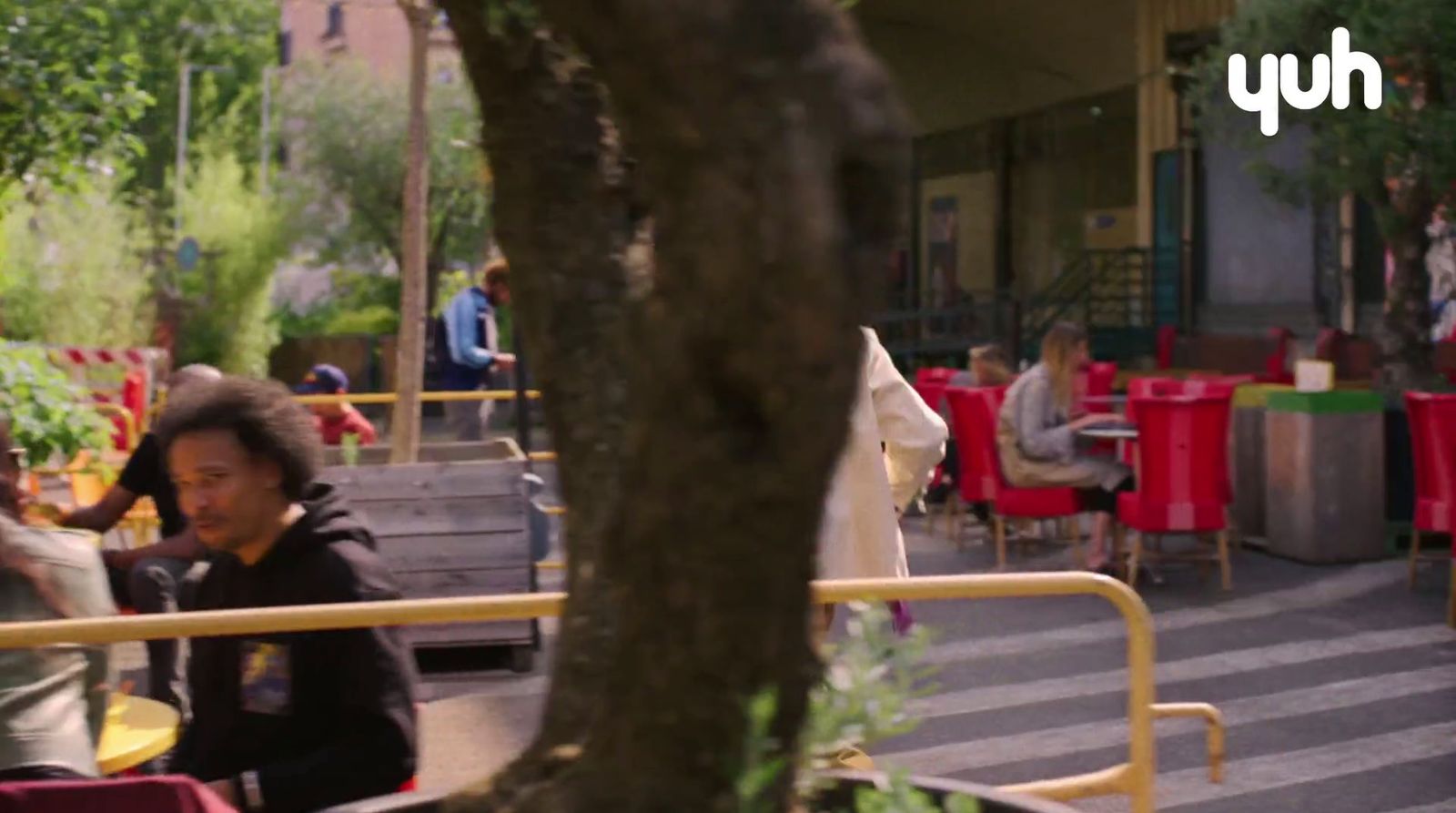 a group of people sitting at a table outside