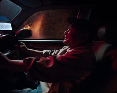 a man driving a car in the dark