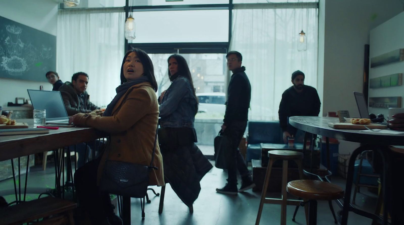 a group of people standing around a table