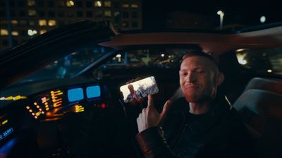 a man sitting in a car holding a cell phone