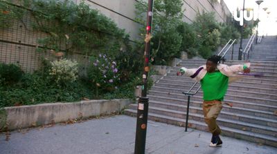 a man is walking down the stairs with a frisbee