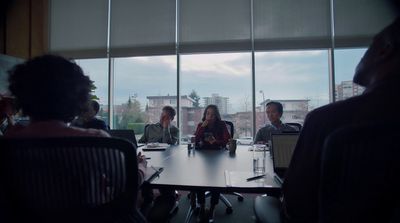 a group of people sitting around a conference table