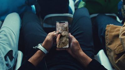 a person holding a cell phone in their hands