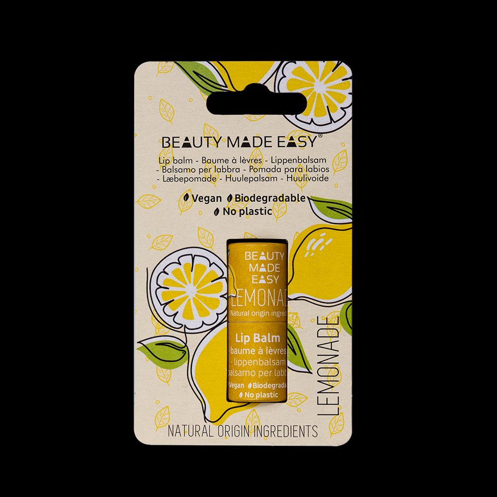 a package of lemon lip balm on a black background