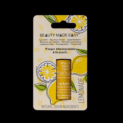 a package of lemon lip balm on a black background