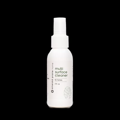 a bottle of multi surface cleaner on a black background