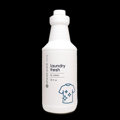 a bottle of laundry freshener on a black background