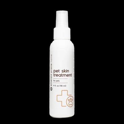 a bottle of pet skin treatment on a black background