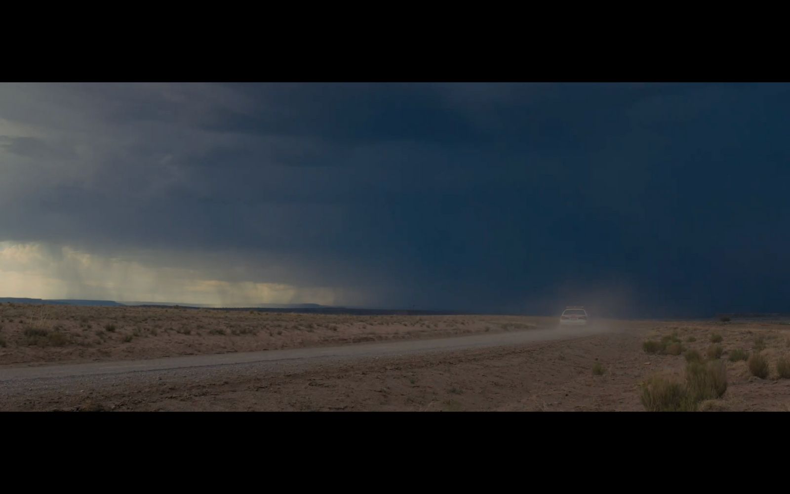 a dirt road in the middle of a desert