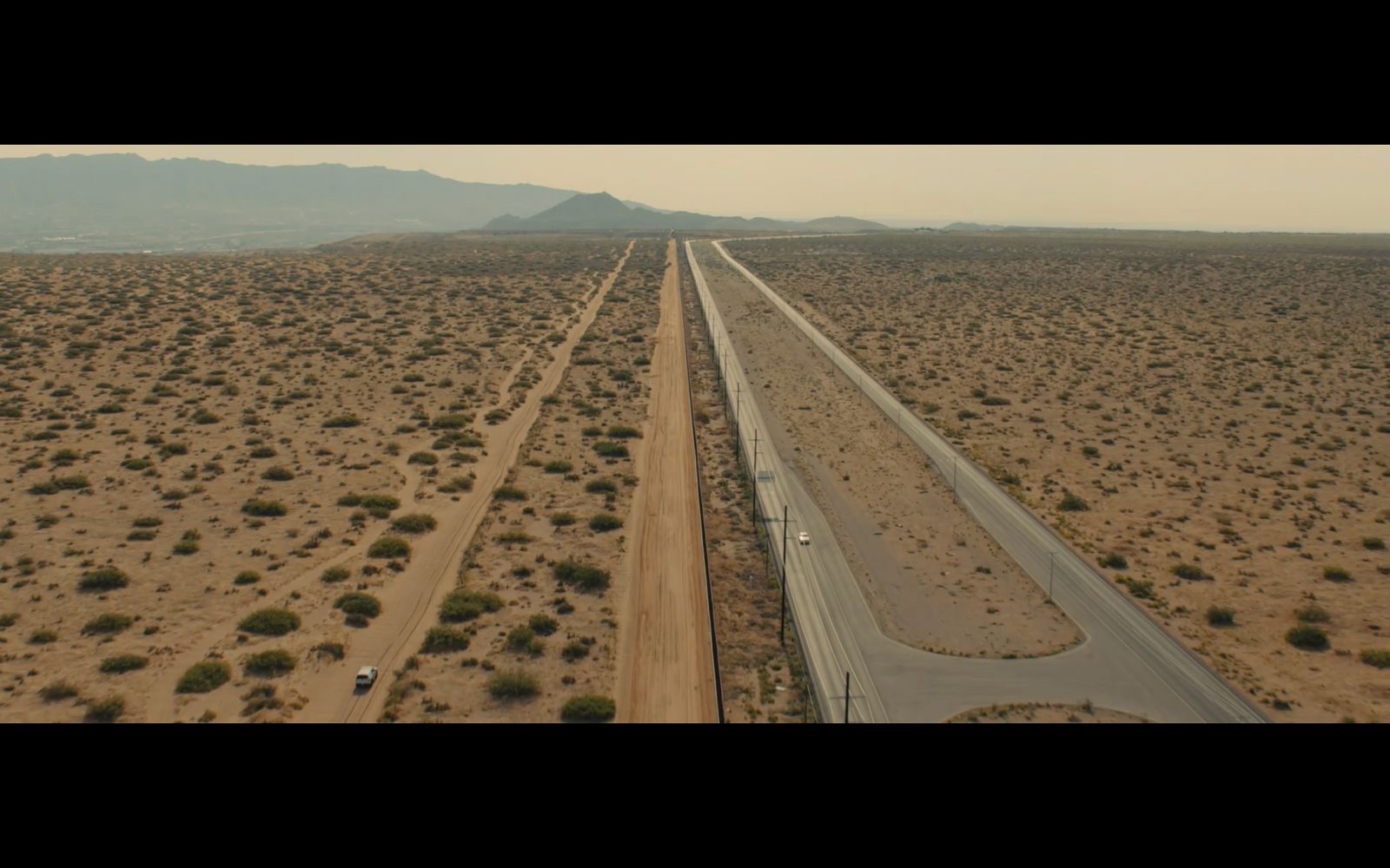 an aerial view of a highway in the middle of the desert