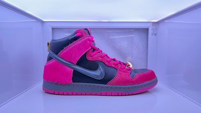 a pair of pink and blue sneakers in a display case