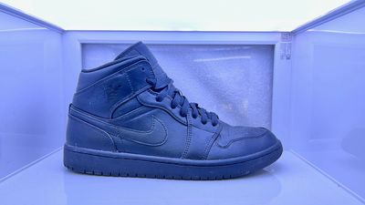 a pair of blue sneakers sitting on top of a shelf