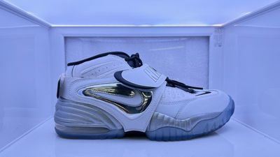 a pair of white and blue sneakers in a display case