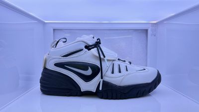 a pair of white and black sneakers on display