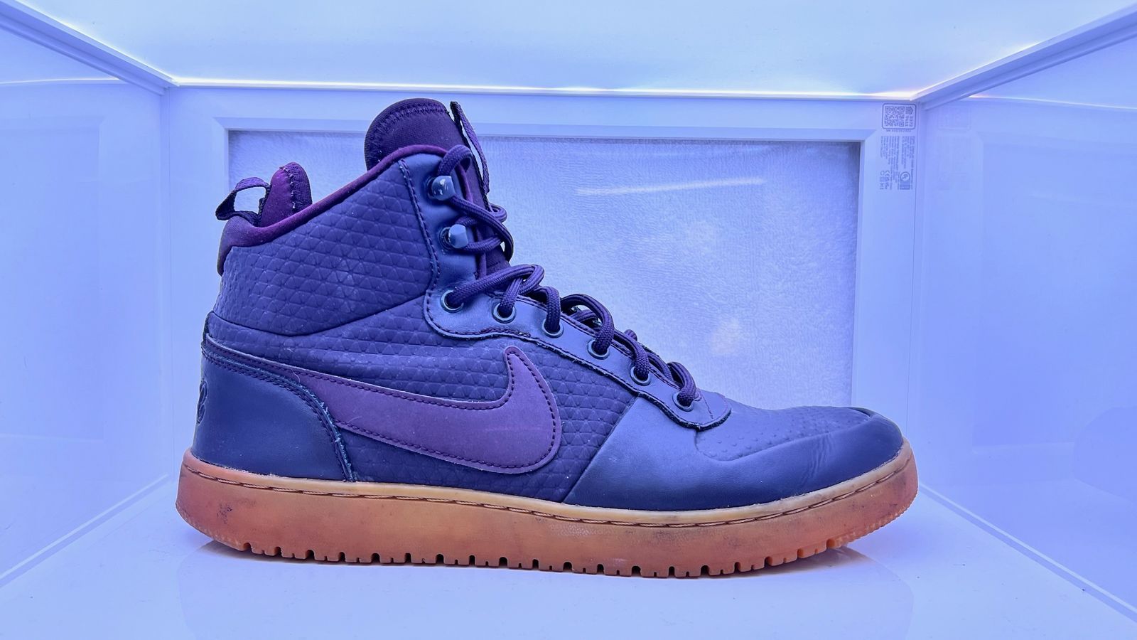 a pair of blue and purple sneakers sitting on top of a counter