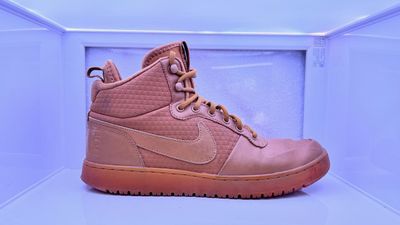 a pair of pink shoes sitting on top of a shelf