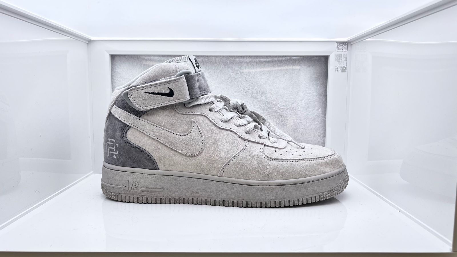 a pair of nike air force sneakers in a display case