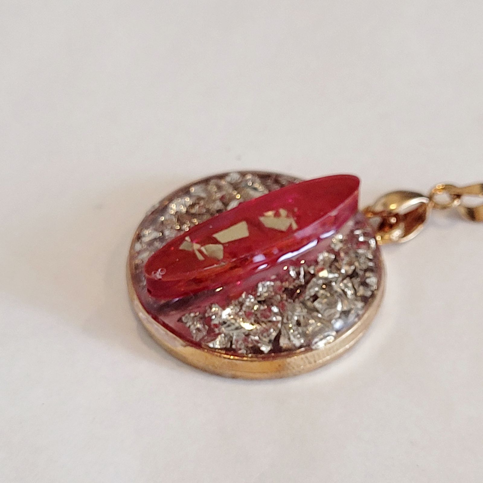 a gold locke with a red ribbon on it