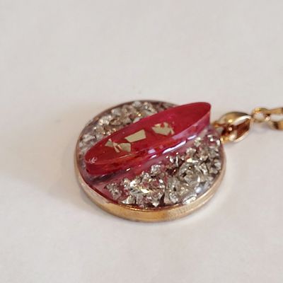 a gold locke with a red ribbon on it