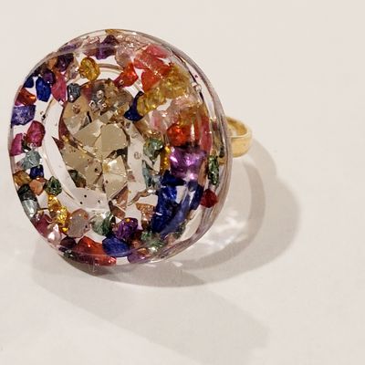a multicolored ring sitting on top of a white table