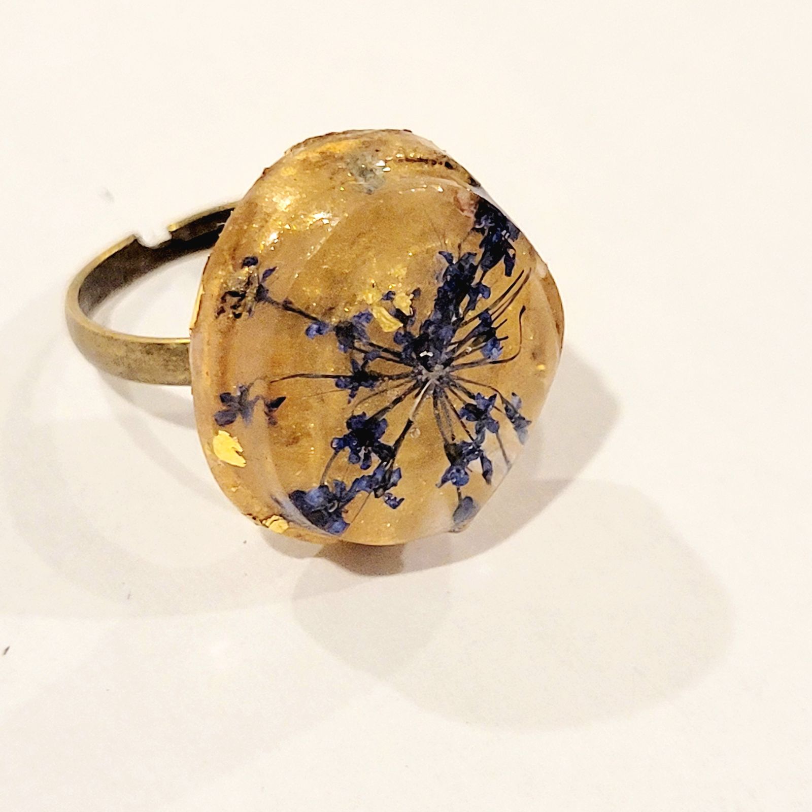a gold ring with blue flowers on it