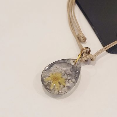 a cell phone is attached to a necklace