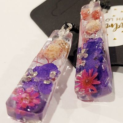 a close up of a pair of earrings on a table