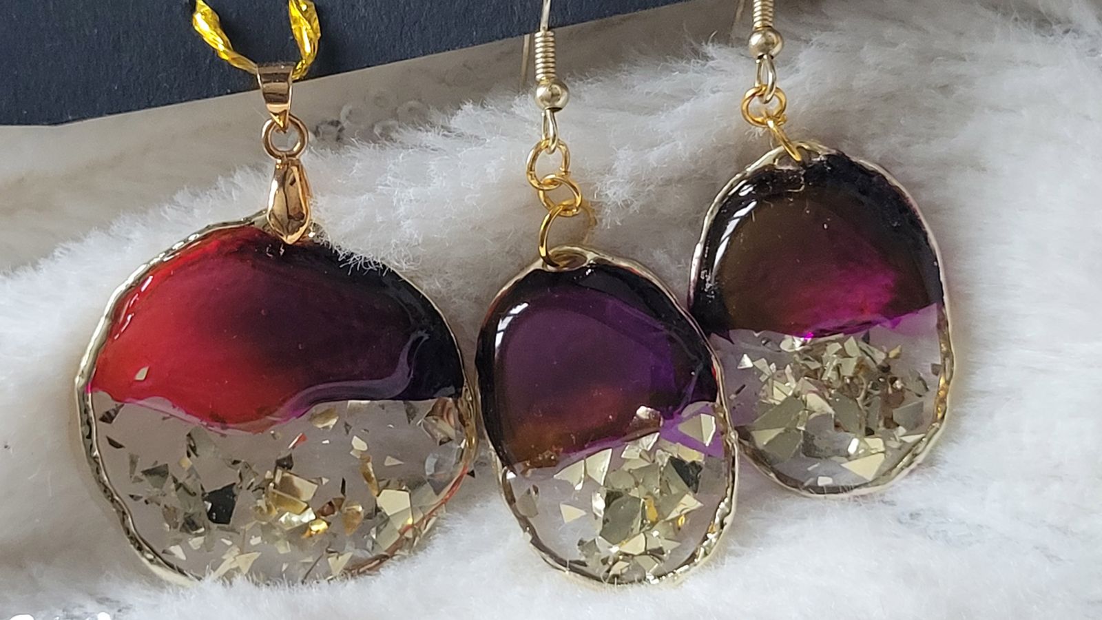 a pair of earrings that are on a white surface