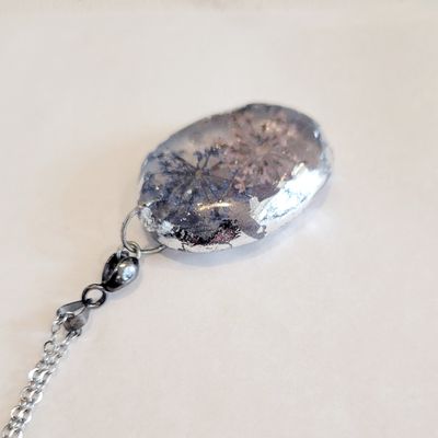 a piece of jewelry with a chain attached to it