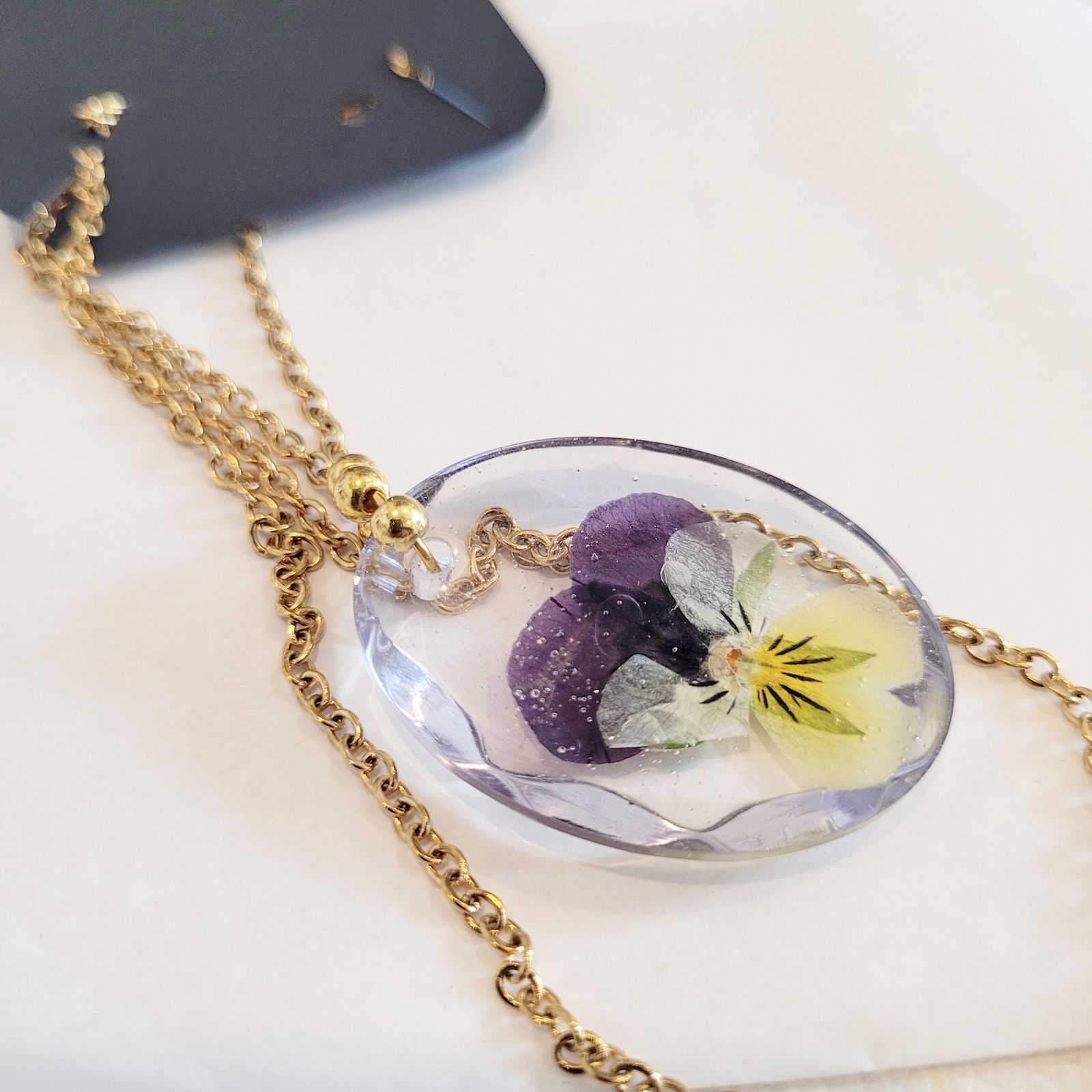 a necklace with a flower inside of it
