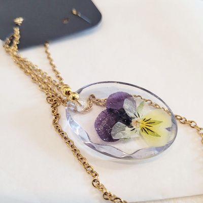 a necklace with a flower inside of it