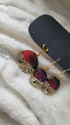 a pair of sunglasses sitting on top of a white blanket