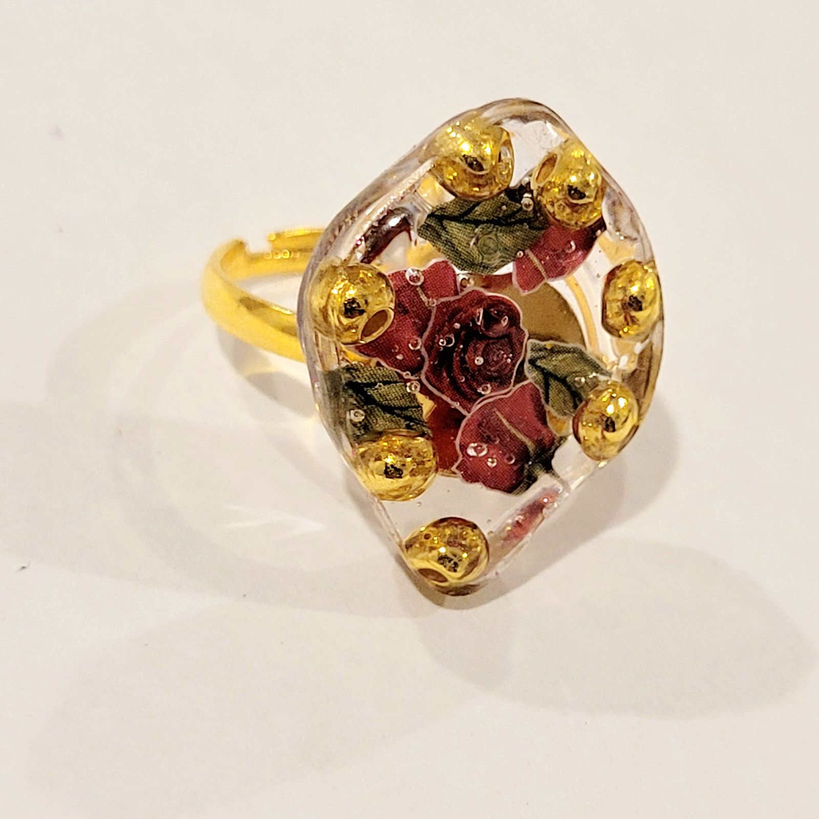 a yellow and red ring with flowers on it