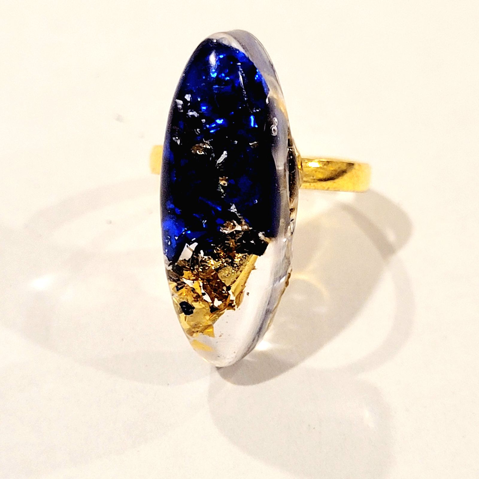 a ring with a blue and yellow stone in it