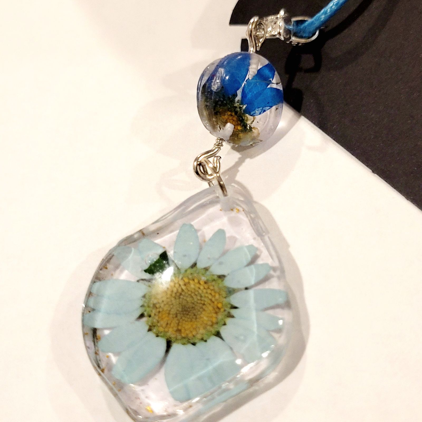 a glass vase with a flower inside of it