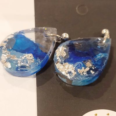 a close up of a pair of earrings on a table