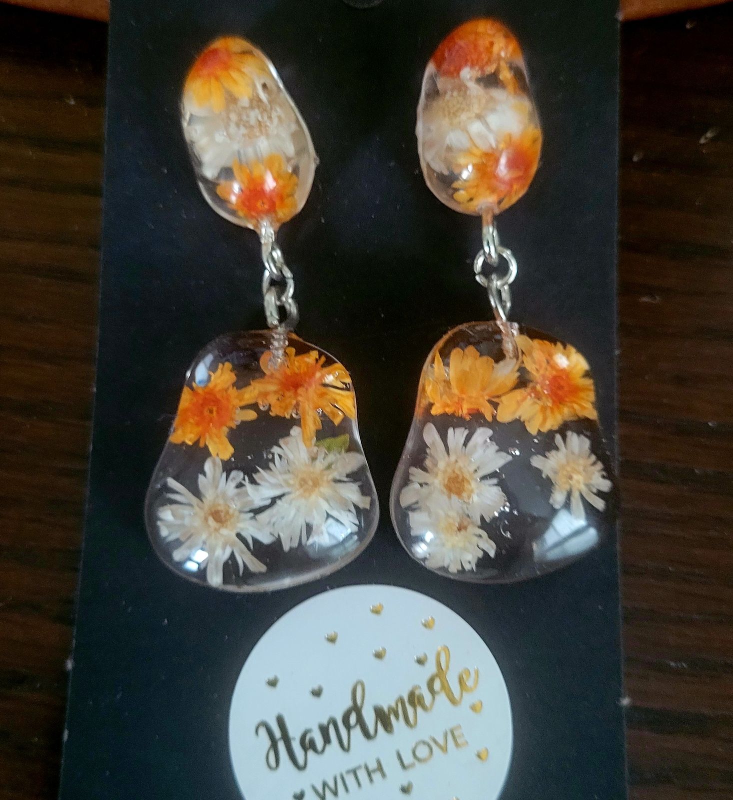 a pair of earrings with flowers on them