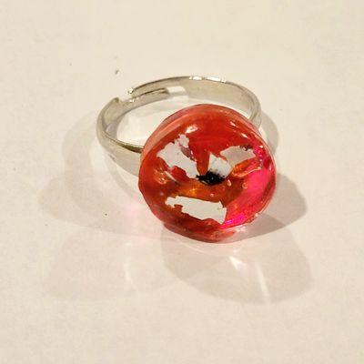 a ring with a red donut on it sitting on a table