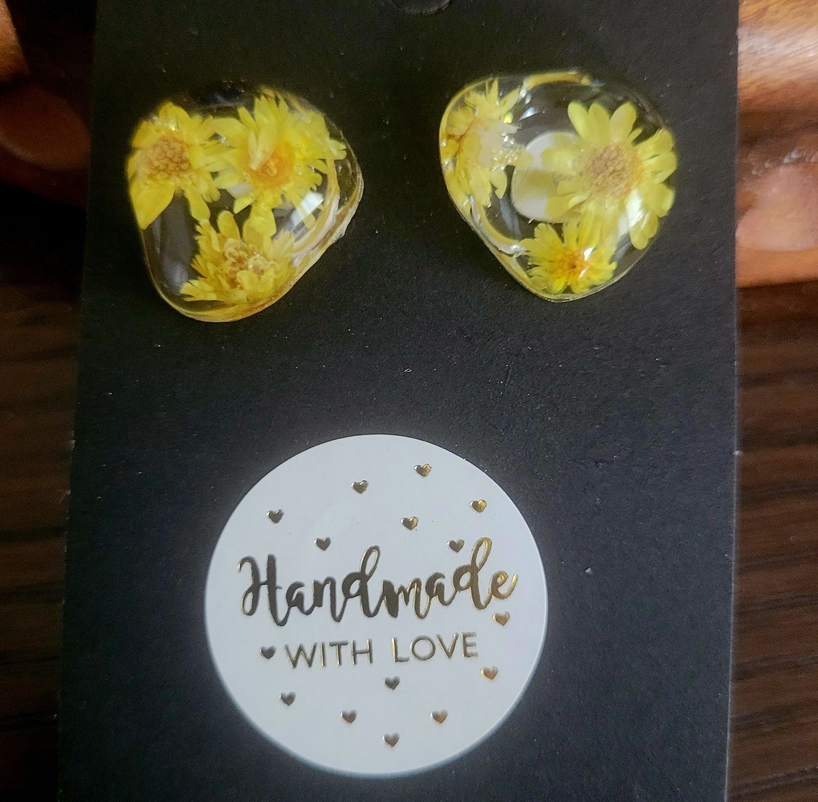 a pair of yellow flowers are on a card