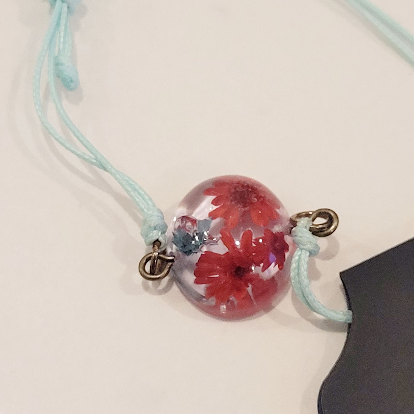 a glass ball with flowers on a string
