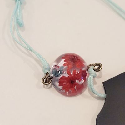 a glass ball with flowers on a string