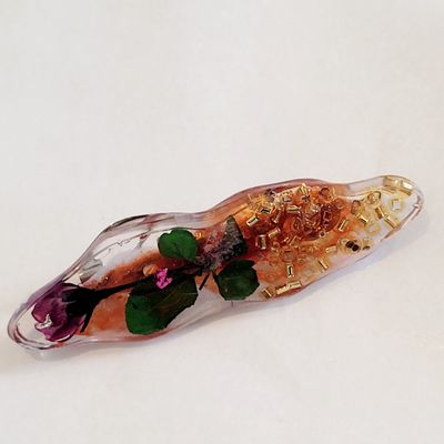 a glass bottle with a flower inside of it