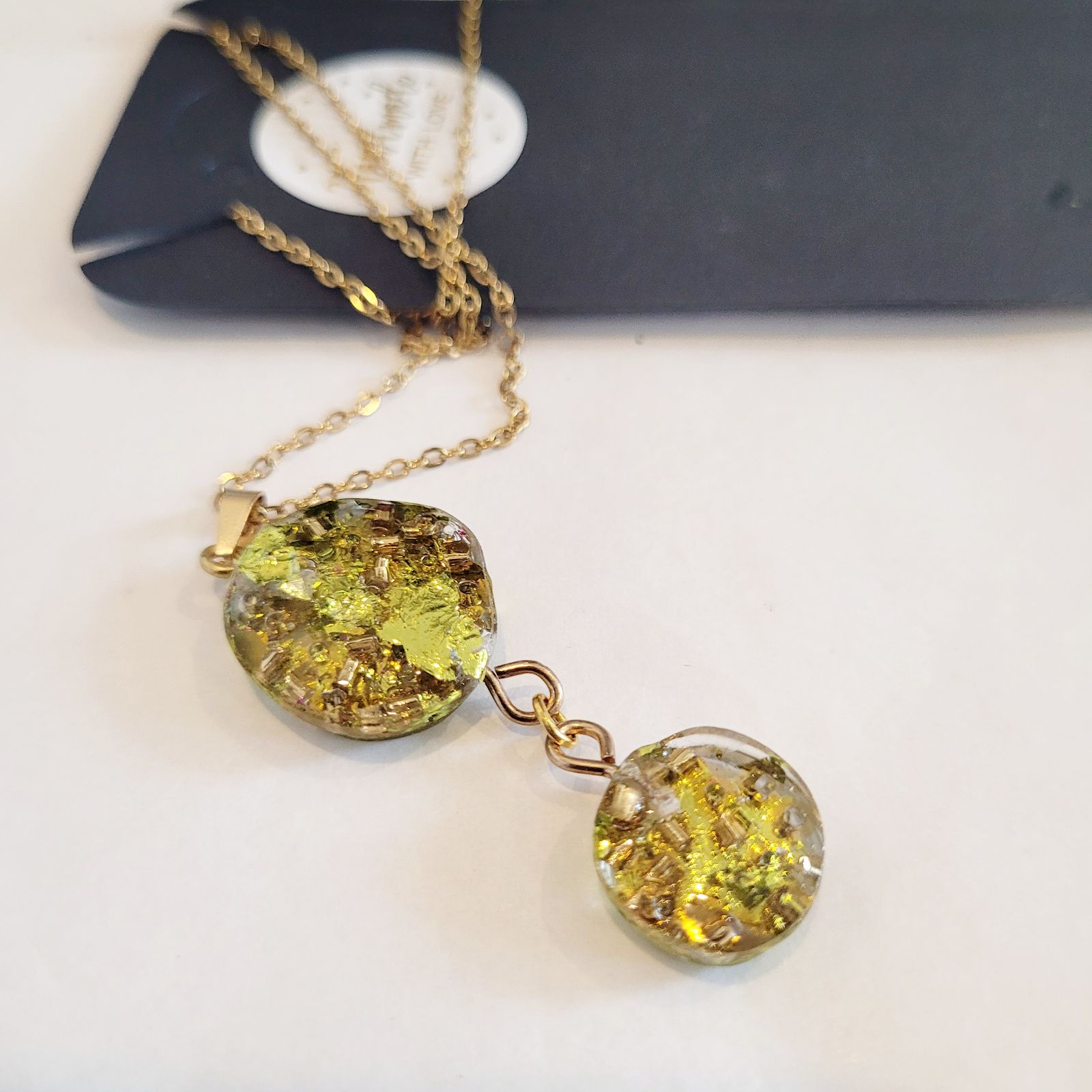 a couple of necklaces sitting on top of a table