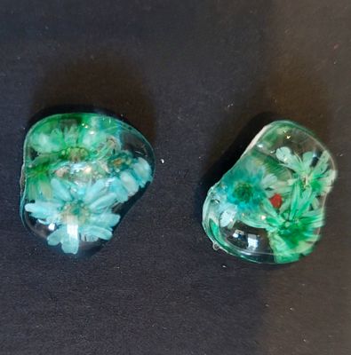 two pieces of glass sitting on top of a table
