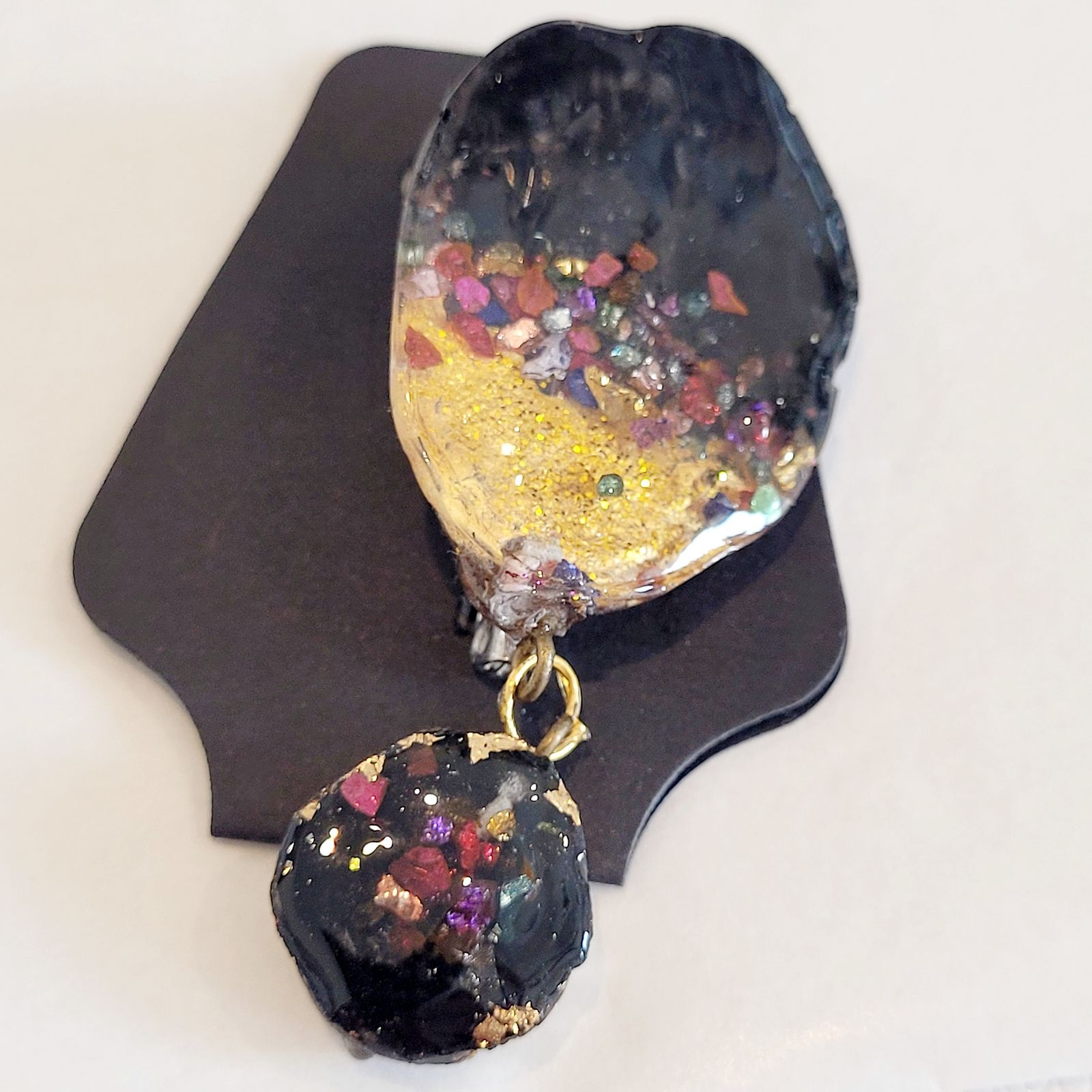 a close up of a pair of earrings on a table