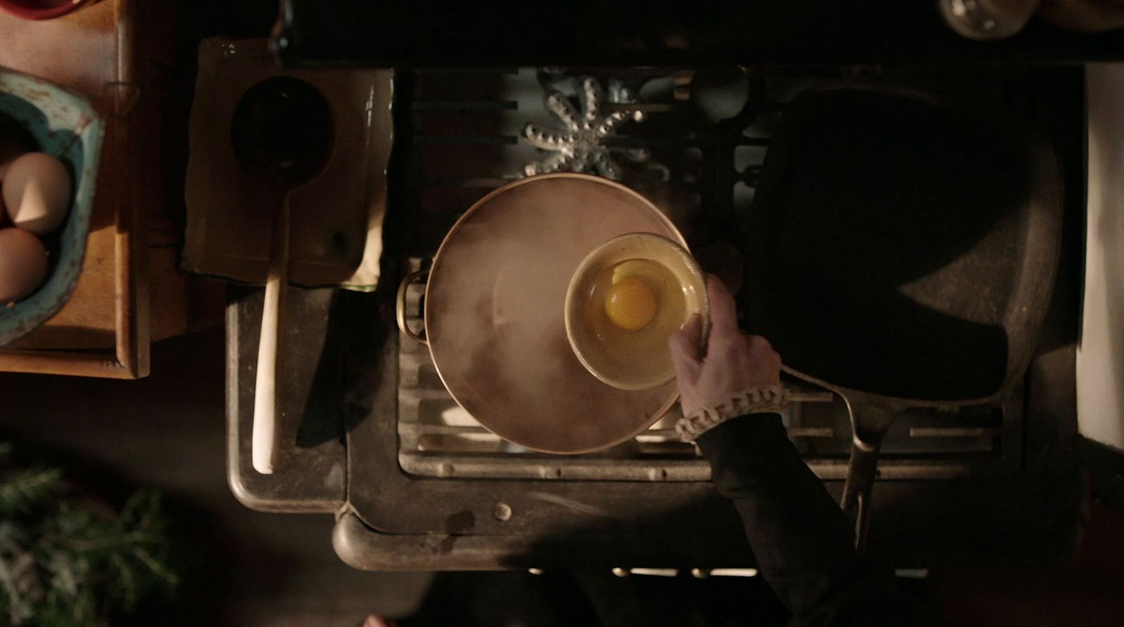 a person pouring a cup of liquid into an oven