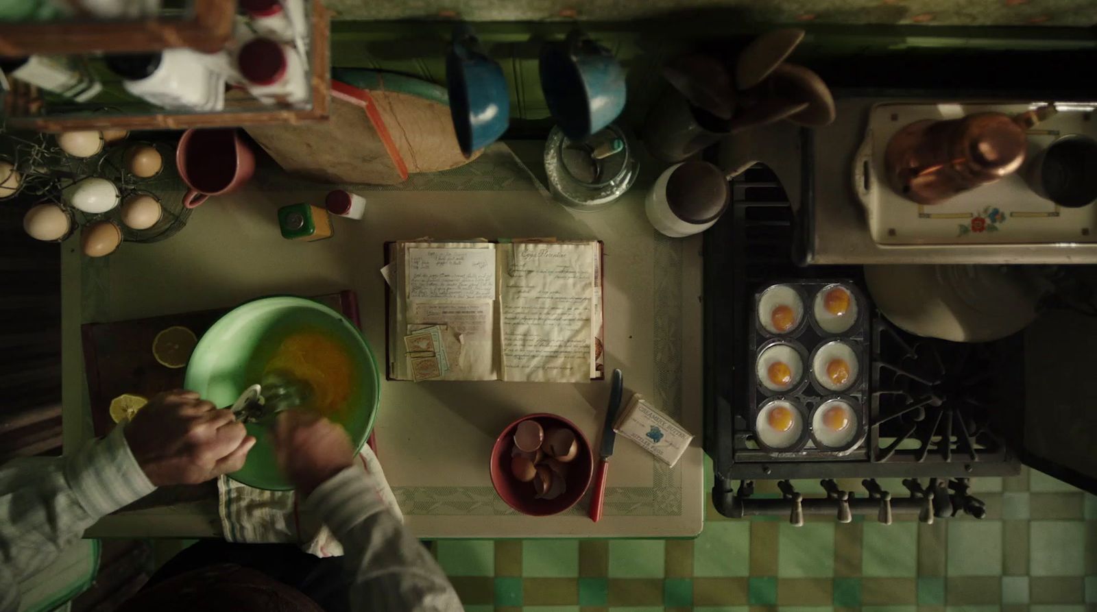 a person holding a green plate in a kitchen