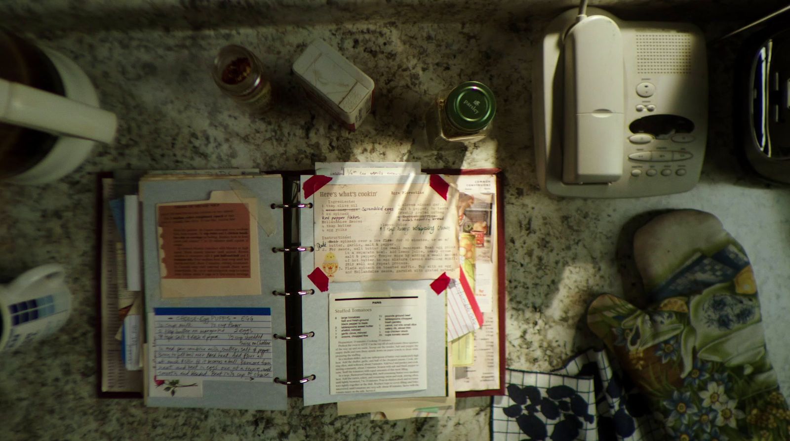 an open book sitting on top of a table next to a phone