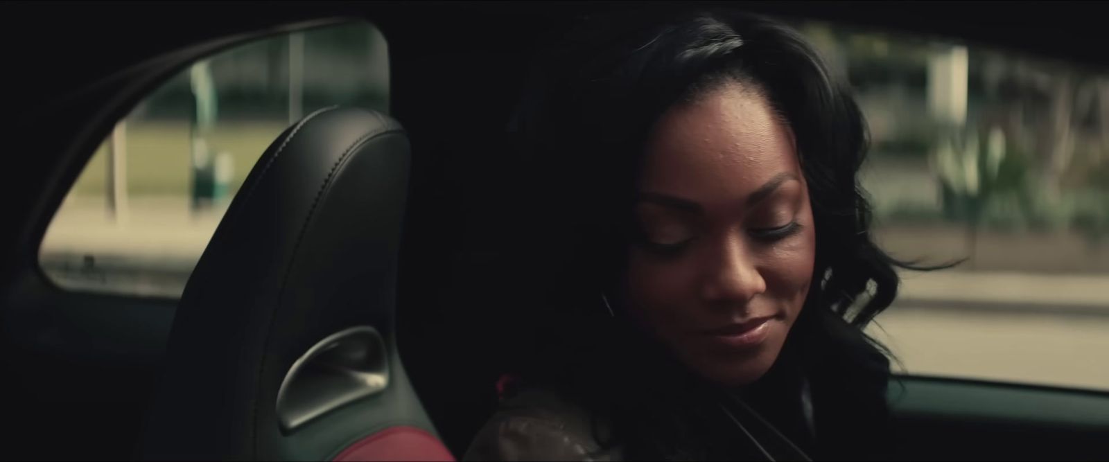 a woman sitting in the back seat of a car